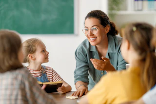 Teacher with young children at table